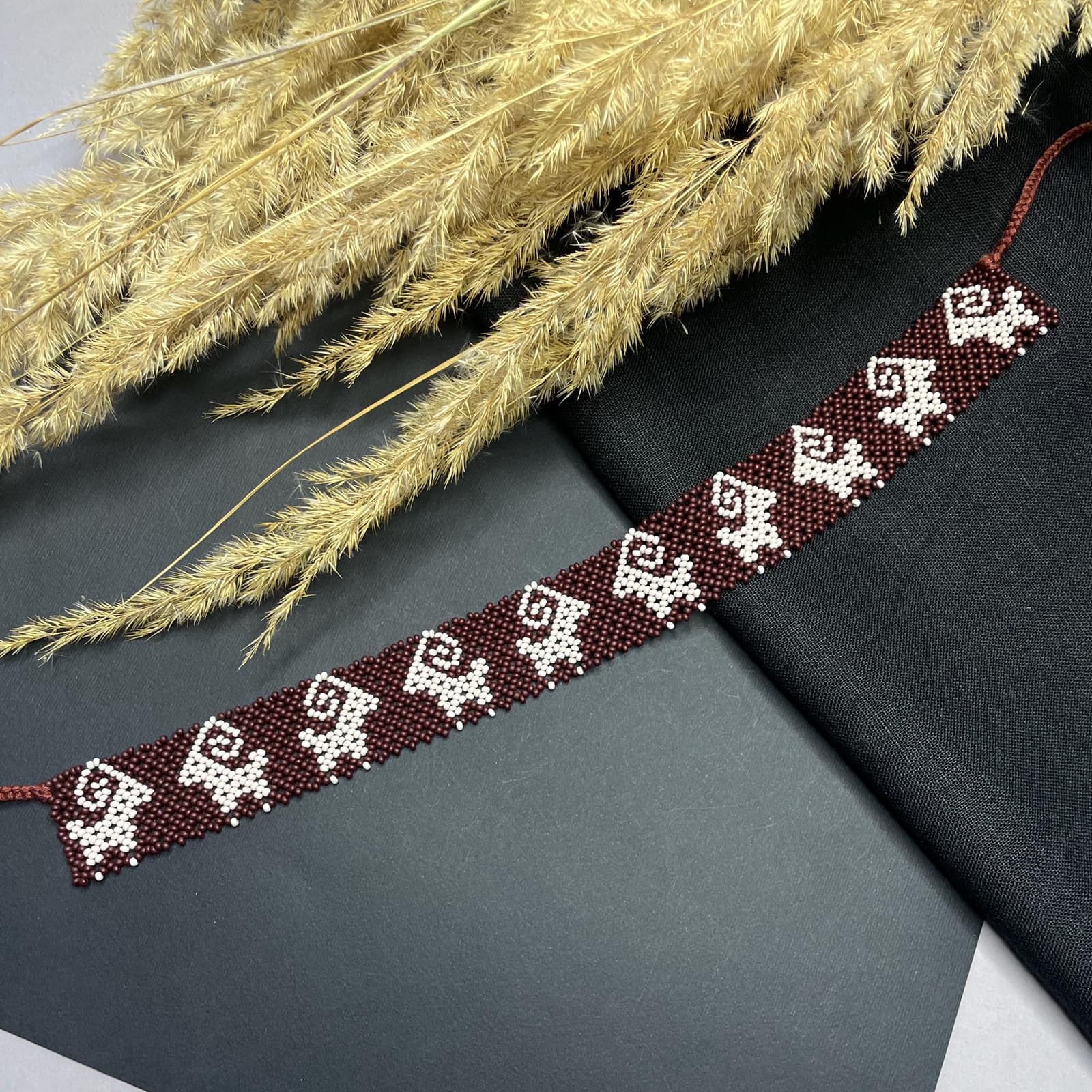Beaded choker with a repeating row of woven sheep