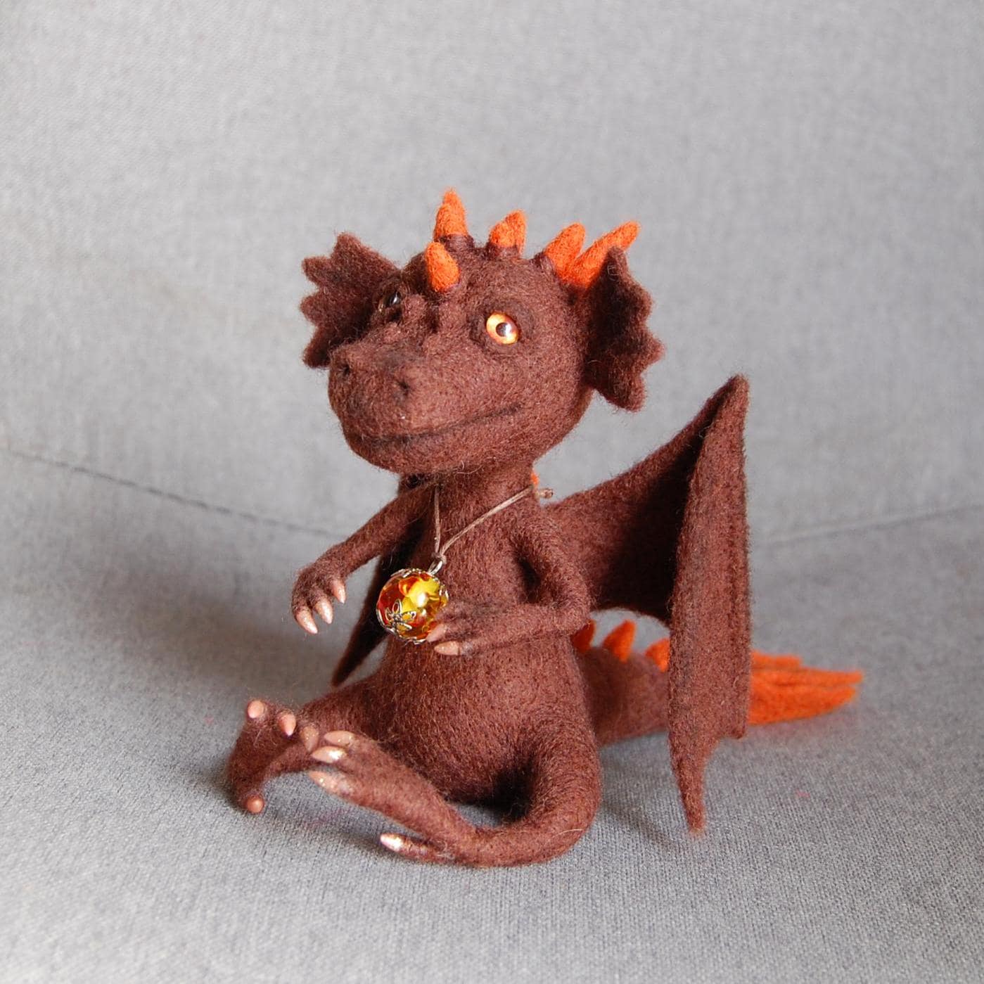 Needle-felted brown dragon sculpture with outstretched wings