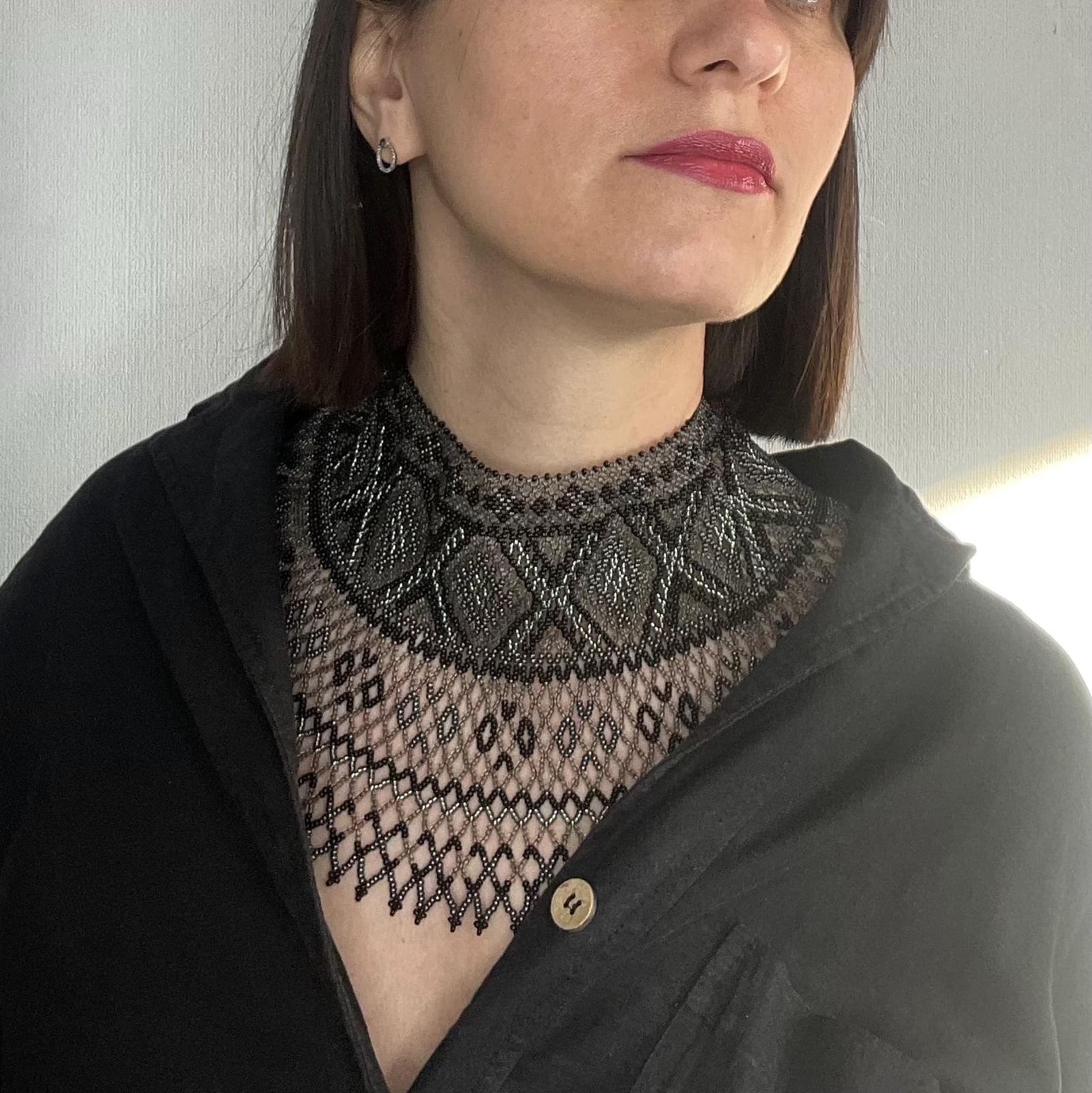 The black collar worn against bare shoulders