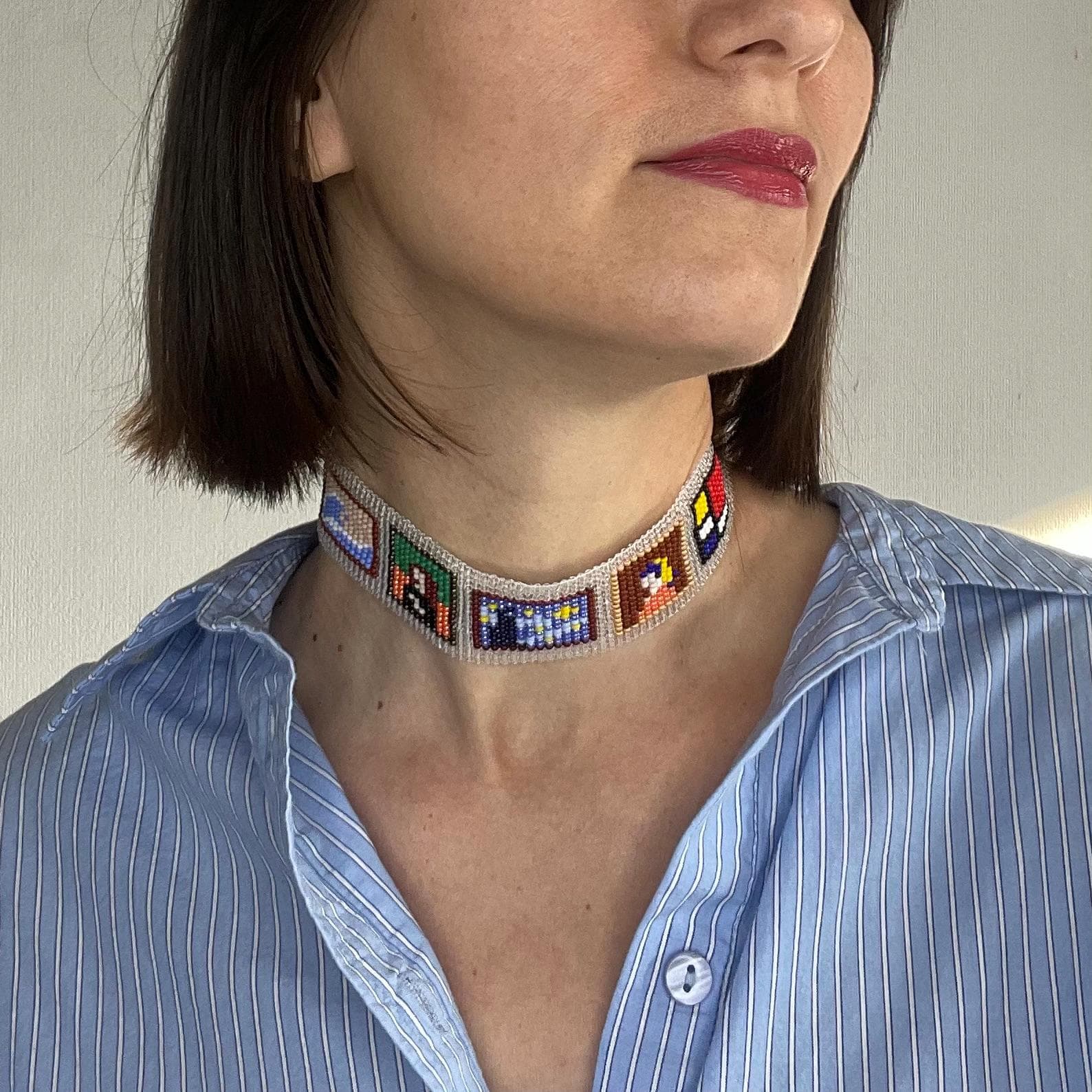 Loom-woven beaded choker with small panels resembling miniature paintings