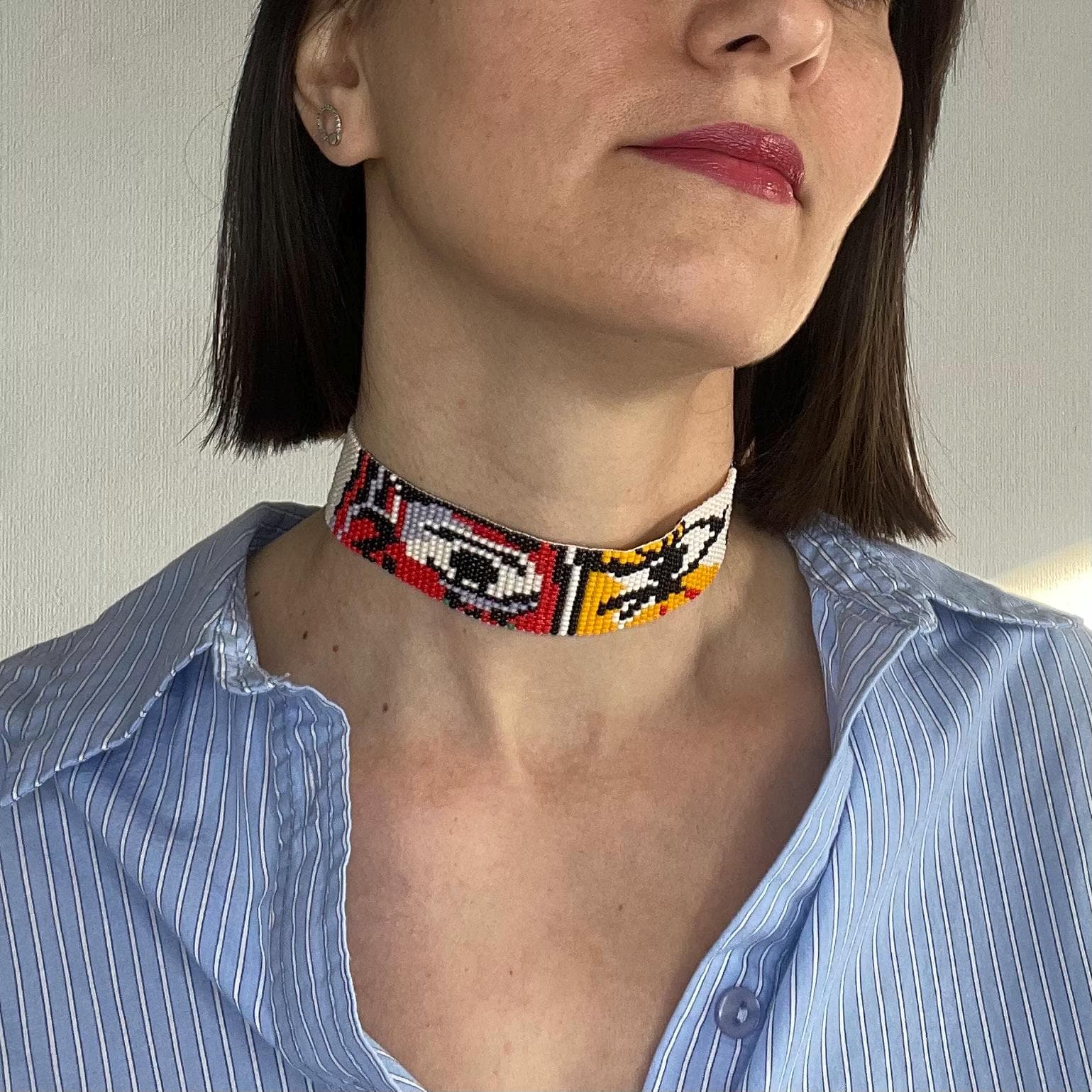 Beaded choker woven with a cubist portrait in bold contrasting colours