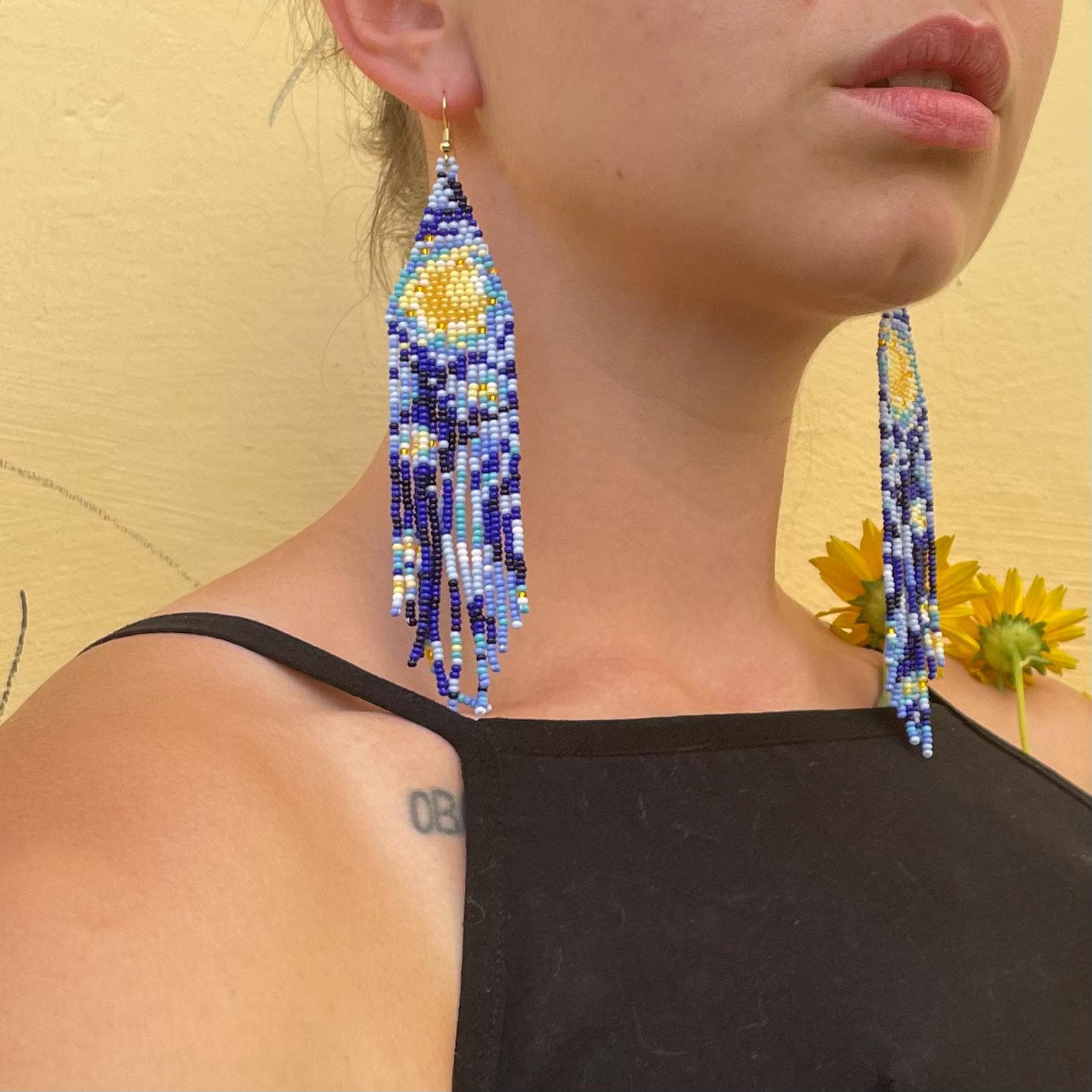 Long beaded earrings woven with the swirling blue and yellow of Van Gogh’s Starry Night