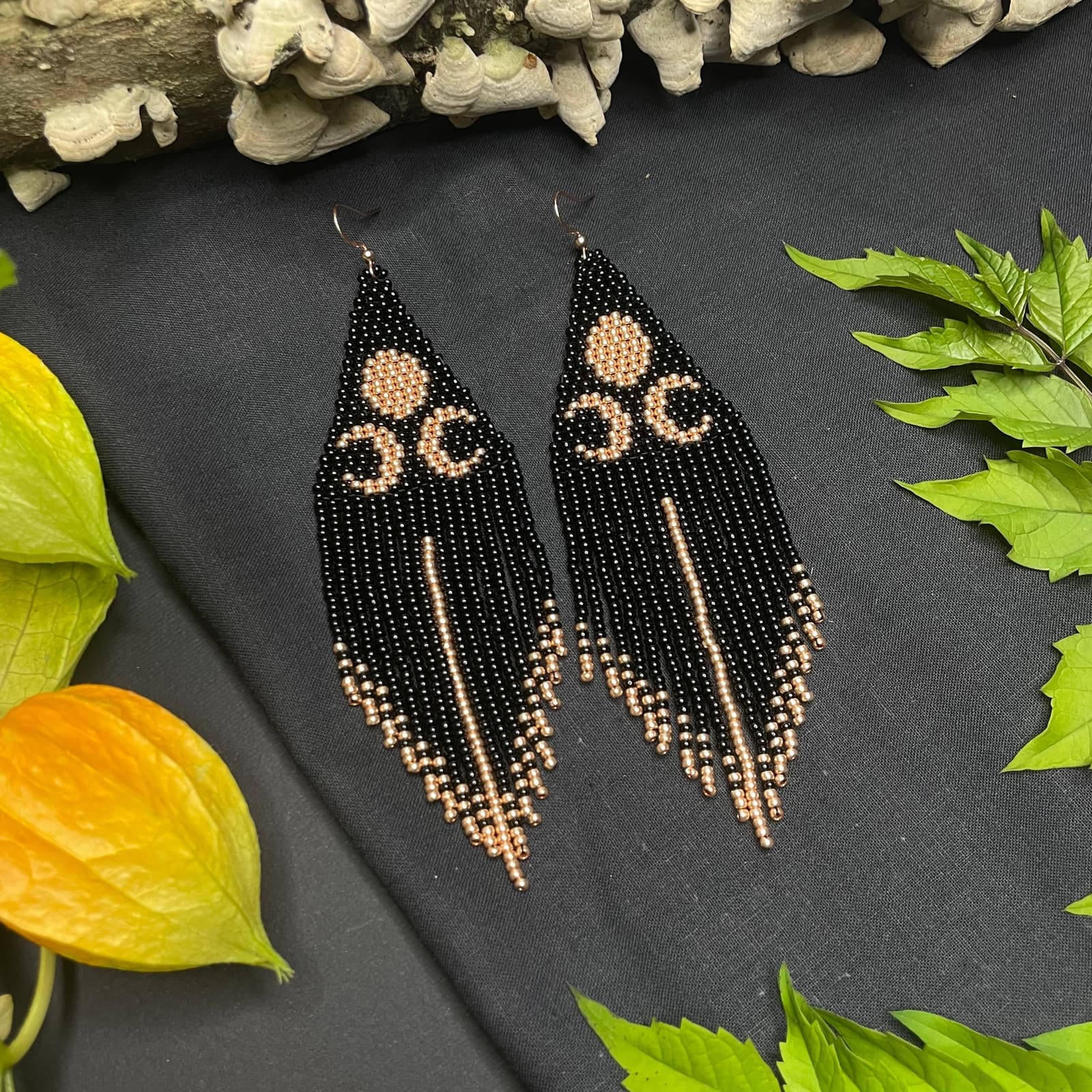 Long black beaded fringe earrings with a crescent moon motif