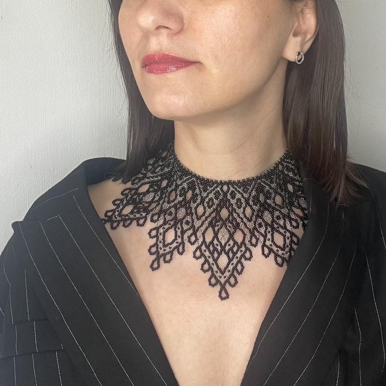 Black beaded choker woven in an openwork lace pattern