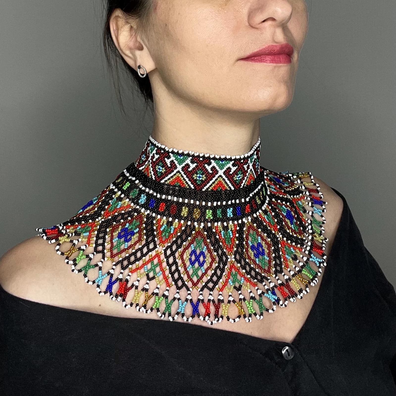 Wide beaded collar in black, white, red, green and blue geometric pattern with fringe