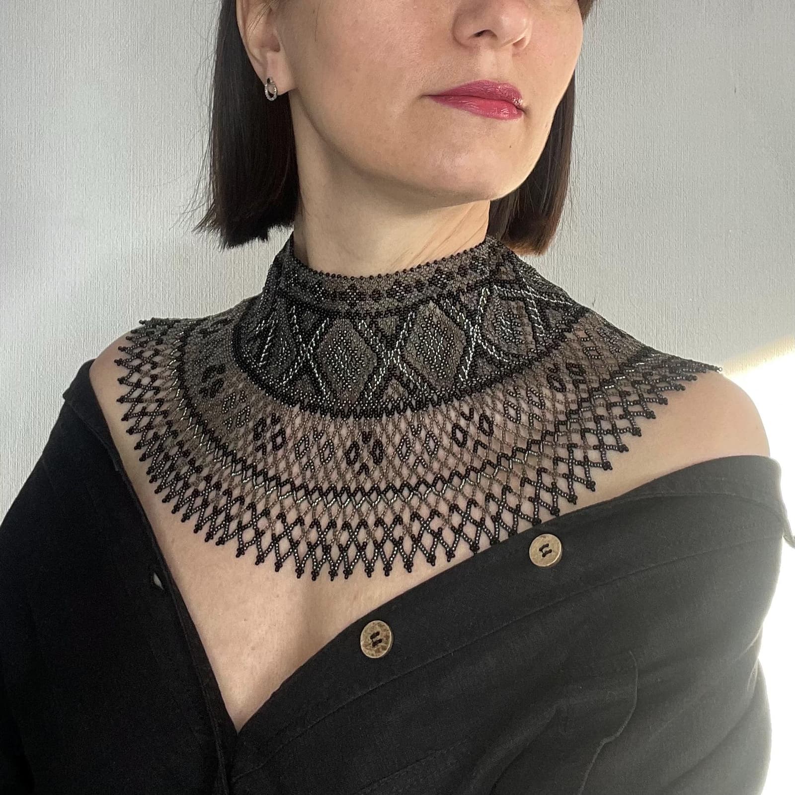 Wide black beaded collar with open lace-like netting